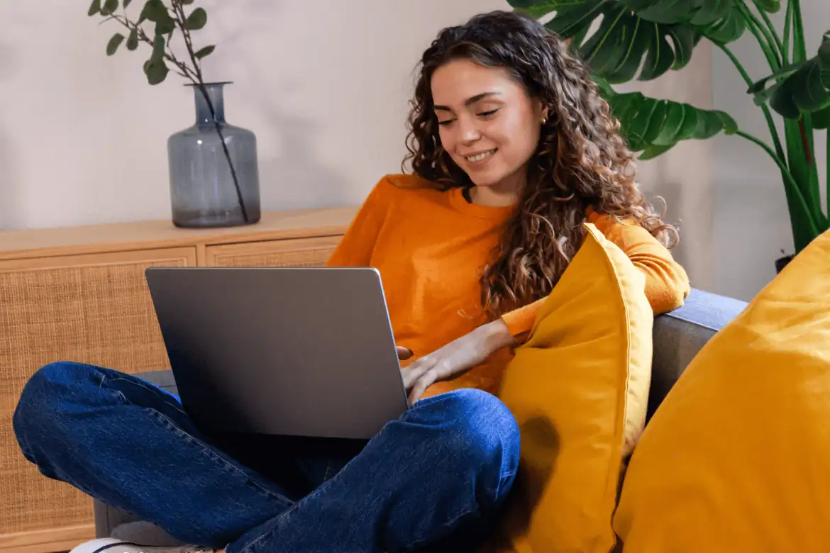 Person learning with laptop on sofa