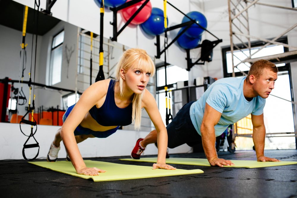 Personal trainer discussing progress with female client