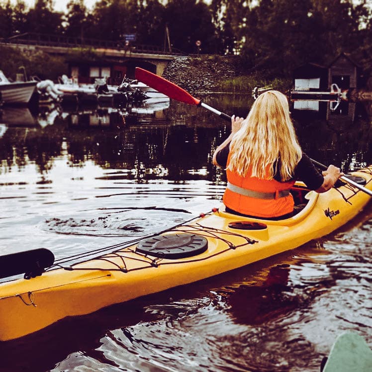 Suzanne canoeing on a lake in Norway. Her I can I will story is to get back there one day.