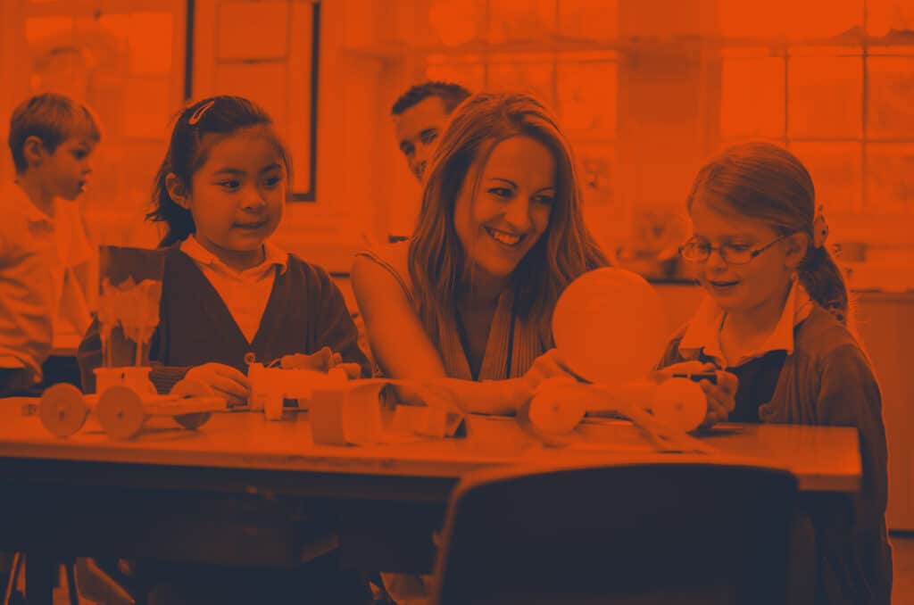 teacher laughing with children