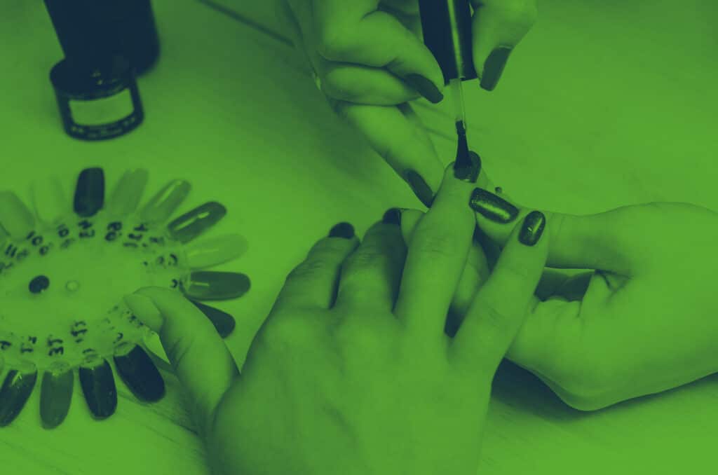 close up of person painting someone's nails
