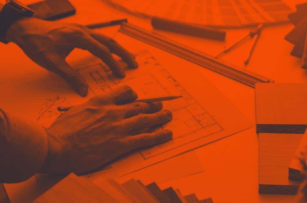 Someone drawing up blueprints of a house