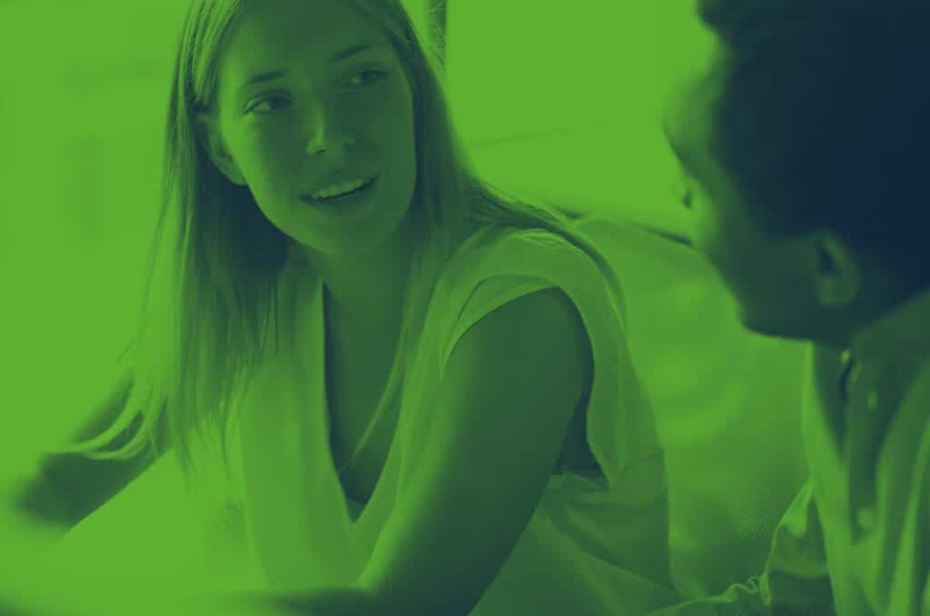 a man and a woman having a conversation on a sofa