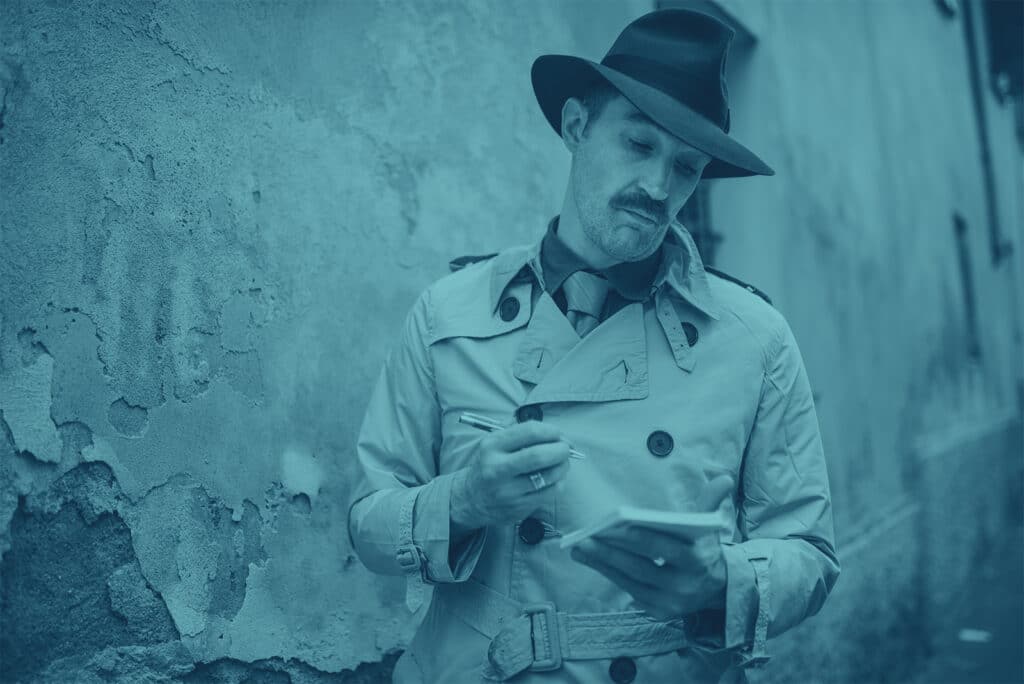 Private investigator in trench coat and deerstalker