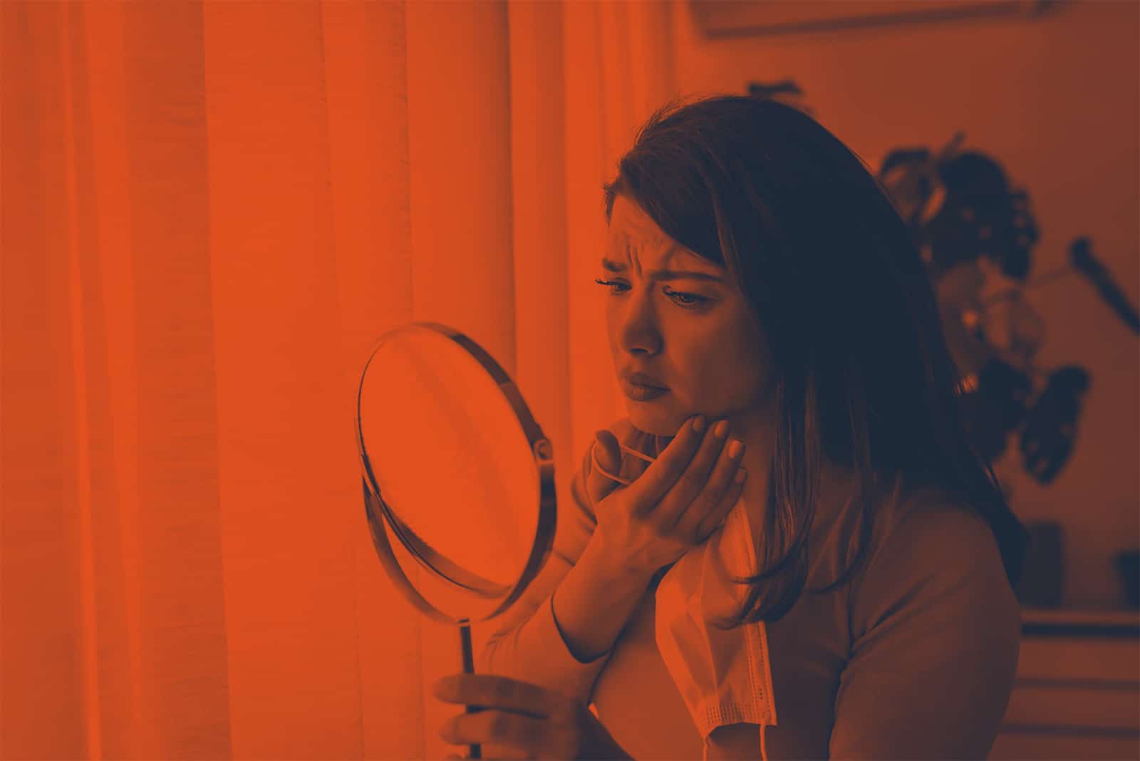 woman looking at mirror