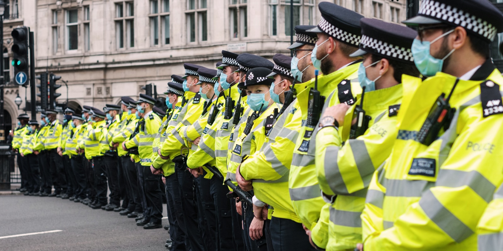 An image of the police force lined up with masks on their faces for a-level law