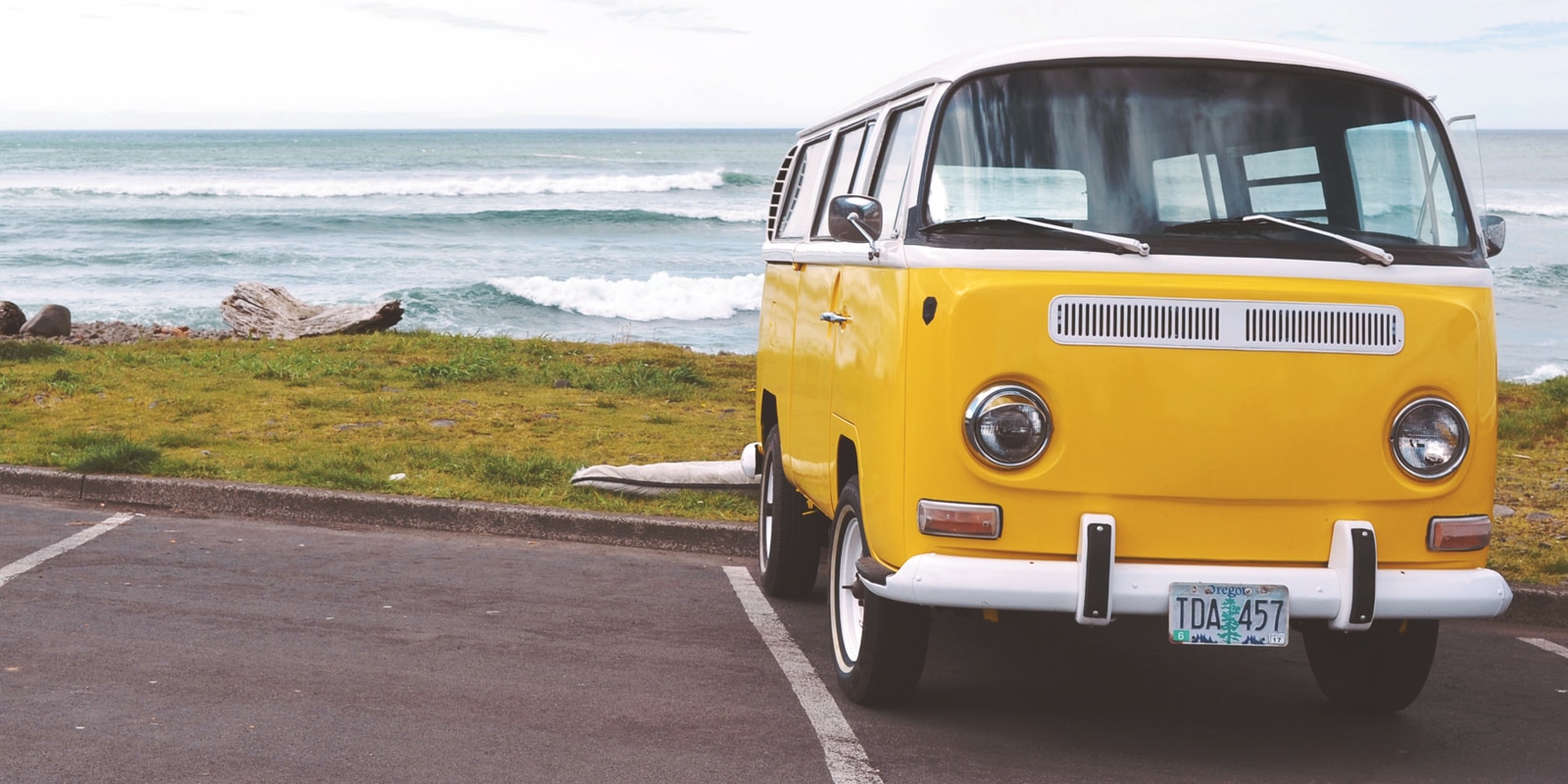 An image of a yellow van parked at a beach