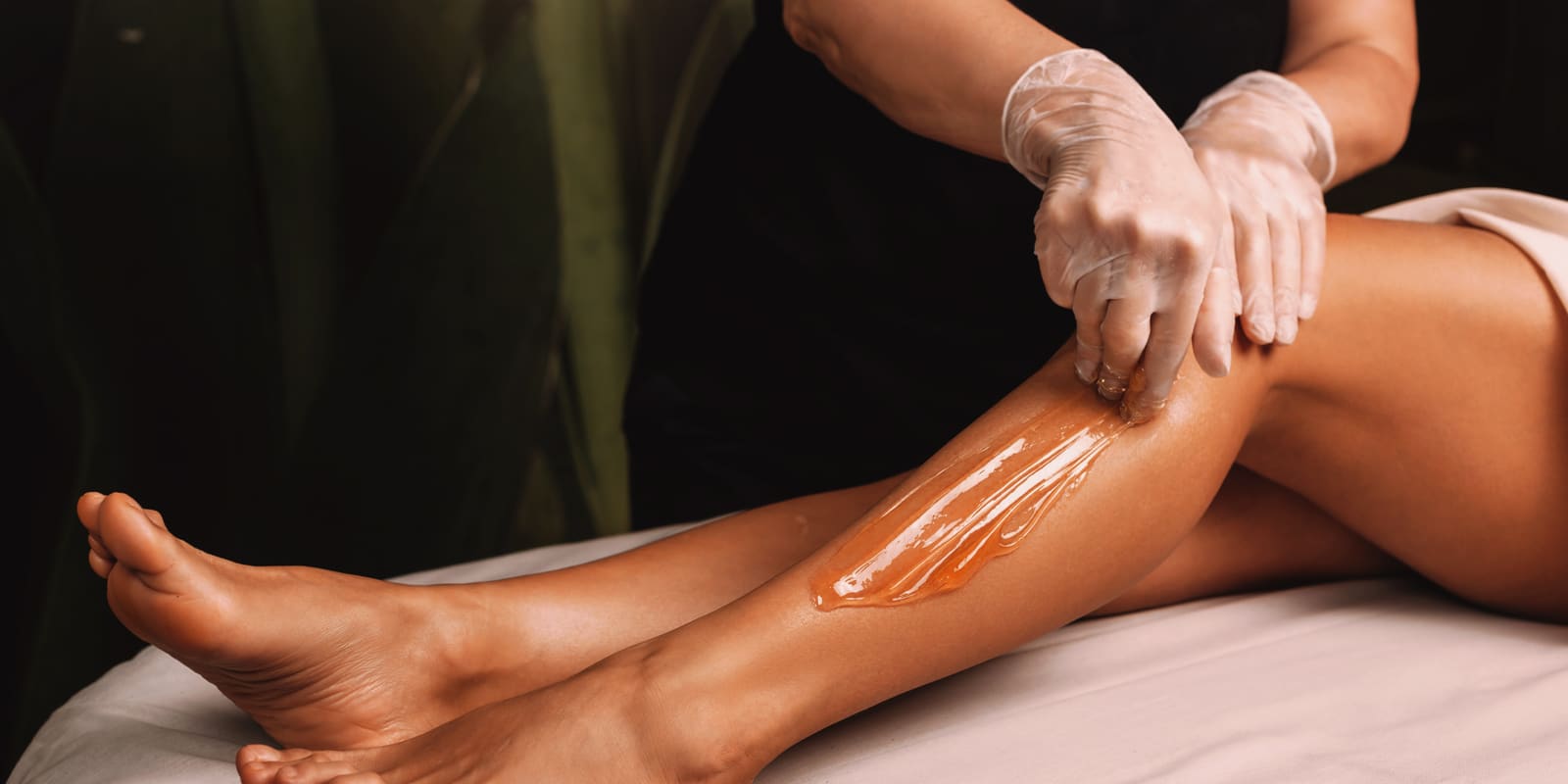 An image of a woman's leg with hot wax on it