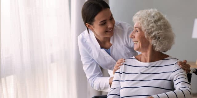 An image of an older woman being cared by a professional carer
