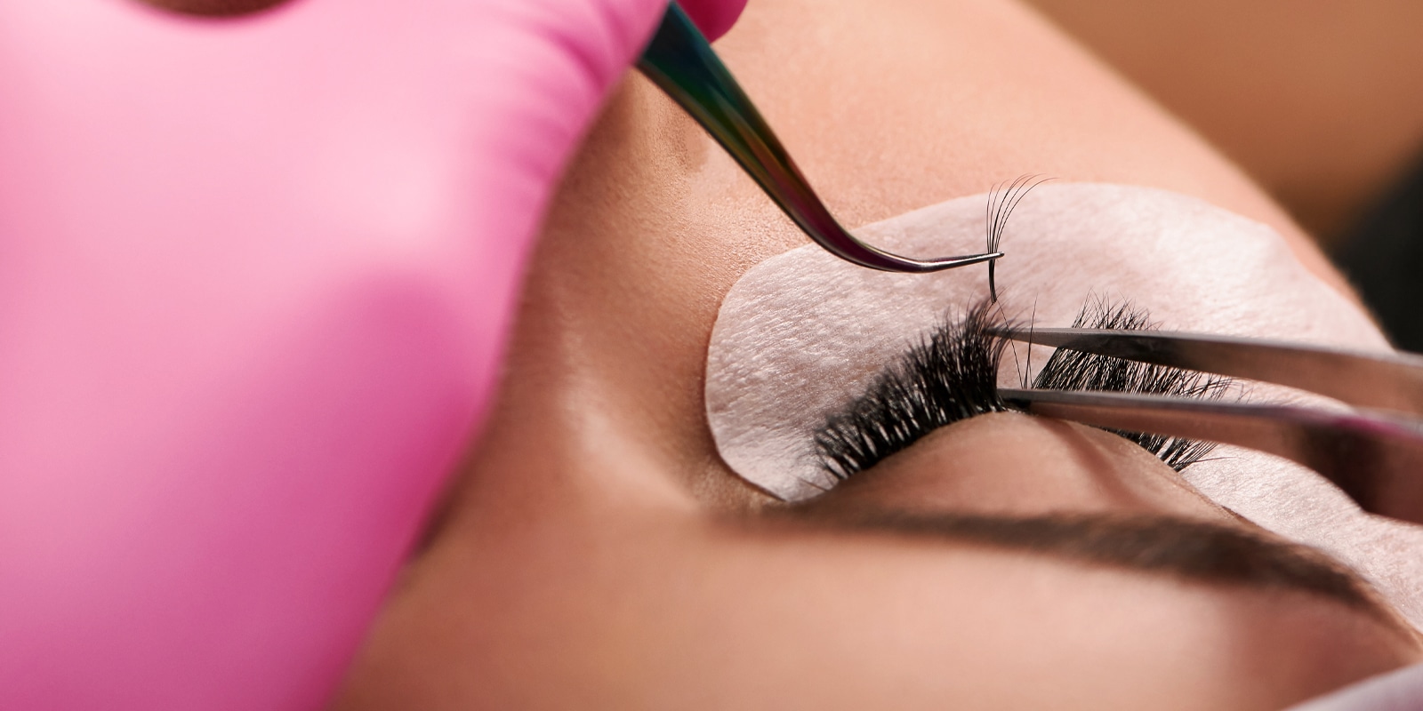 An image of a person getting her eye lash added