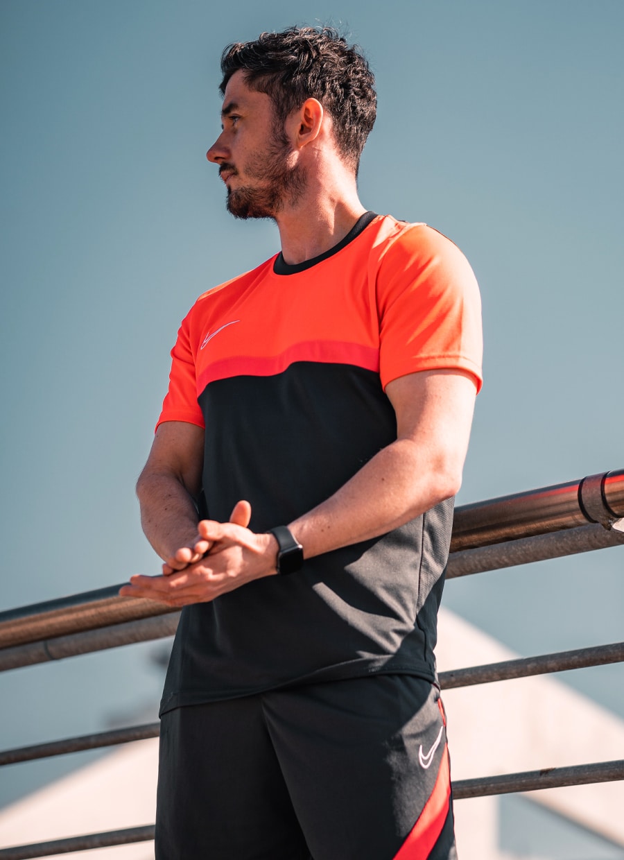 Personal trainer holding clipboard smiling