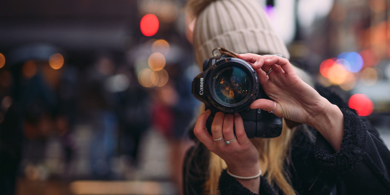 An image of a woman taking a picture with a camera