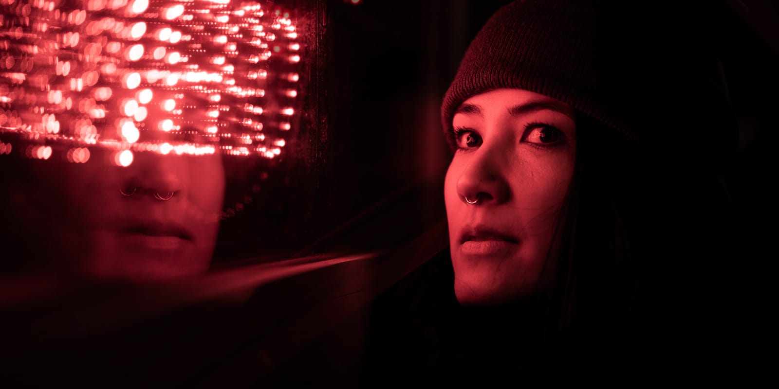 An image with red light flashing on a woman's face