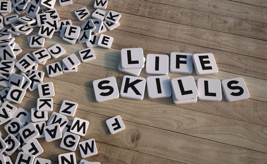 Life skills spelled out using Scrabble tiles.