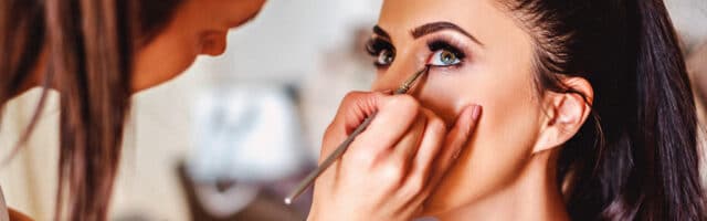 a make up artist applies eye liner