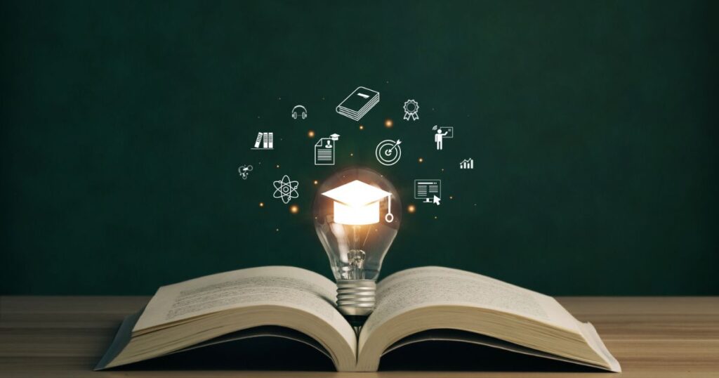 an open book with a light bulb and education icons on it.