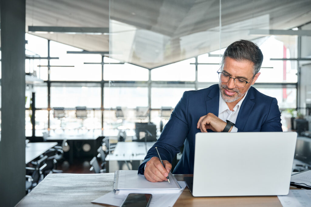 Middle aged smiling professional business man, global company executive.