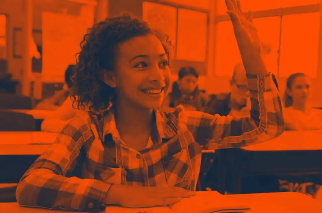 young student holding her hand up