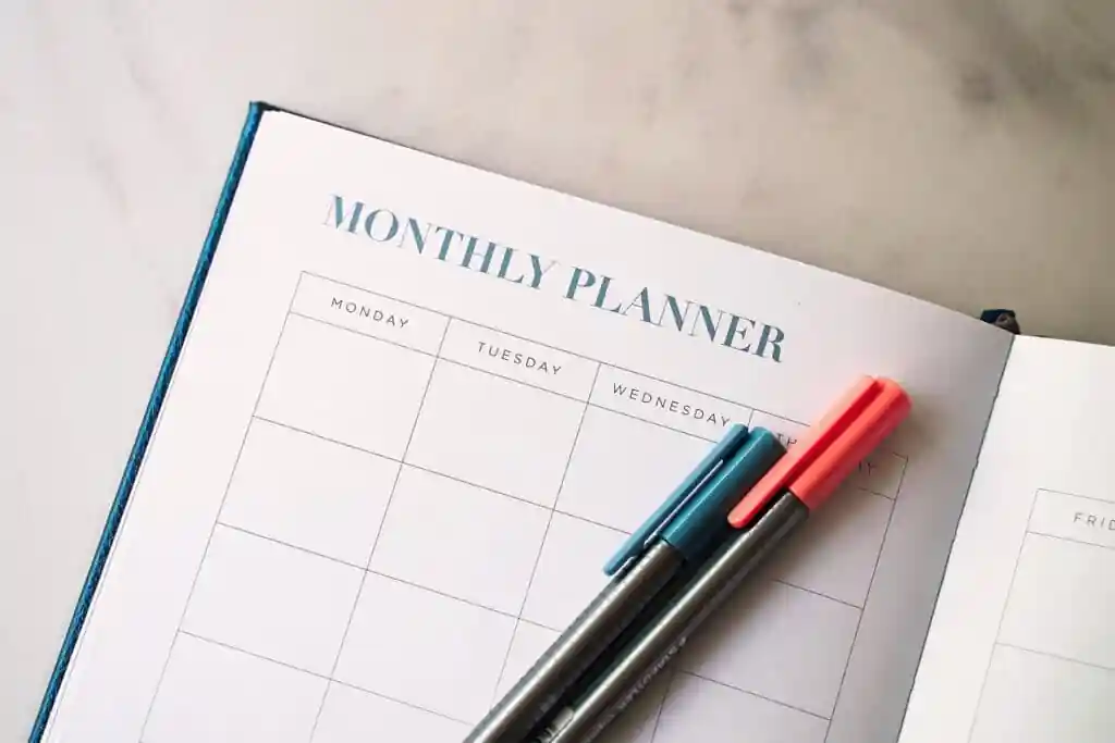 some pens on a monthly planner
